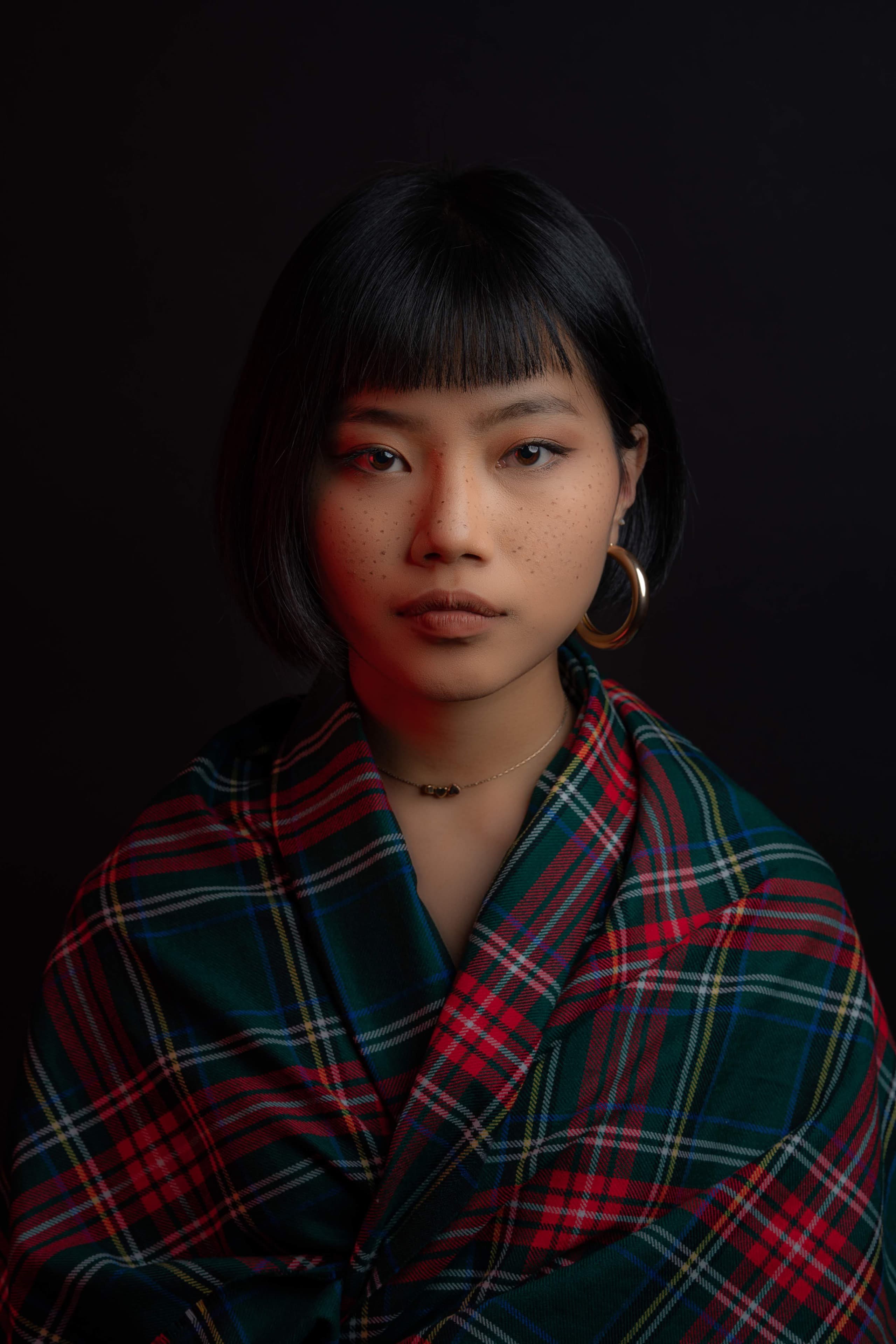 Editorial tartan portrait with a direct gaze
